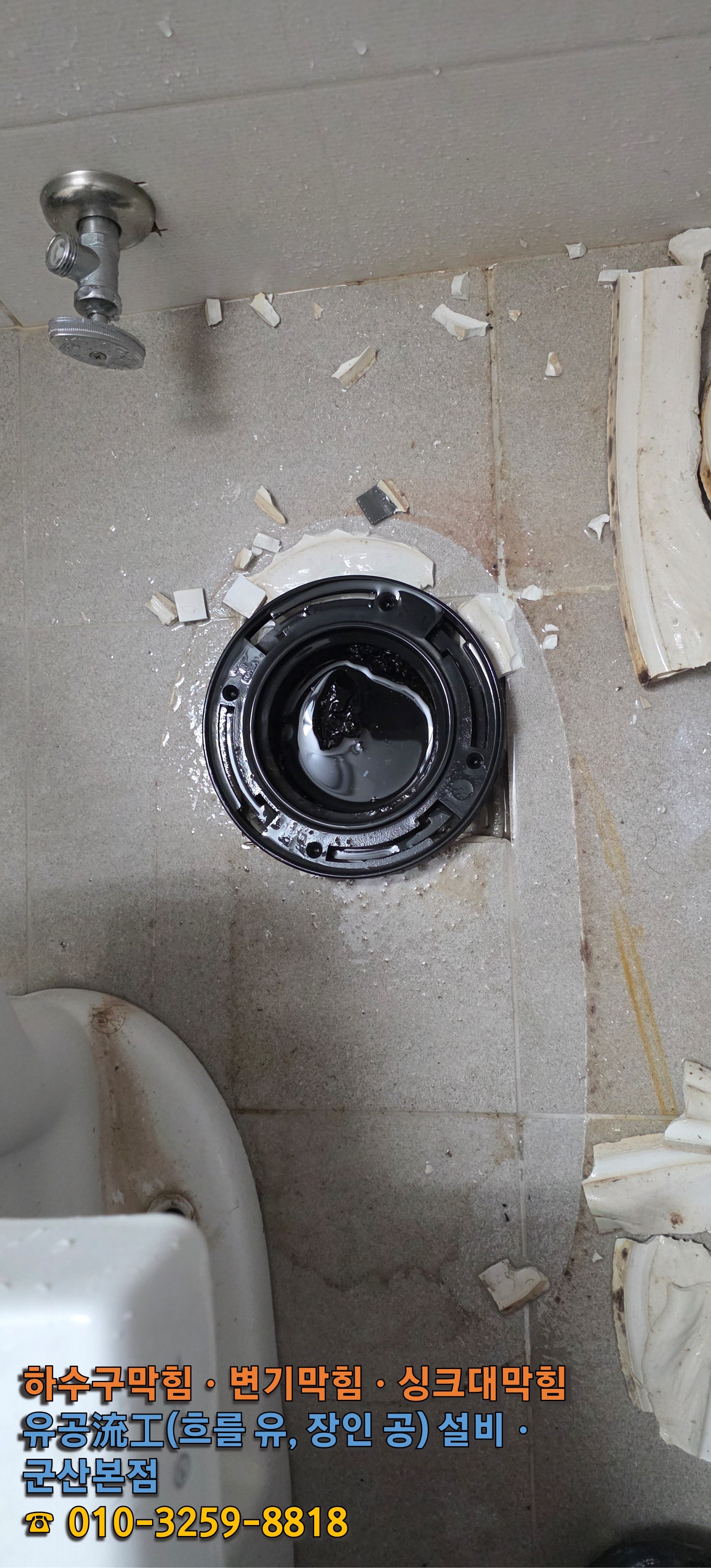 변기를 탈거한 뒤 드러난 배관 내부. 검은색 이물질이 고여 흐름이 완전히 막힌 상태.